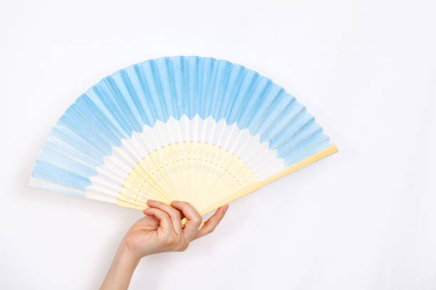 istock woman hold fan in her hand. 697531920