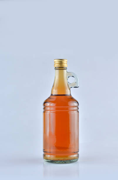 istock Apple Cider Vinegar in a glass bottle over white background 697532284