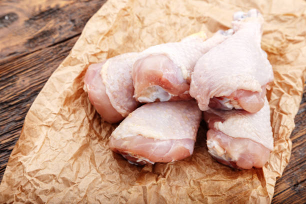 istock Chicken legs on crafty crumpled paper 697532438