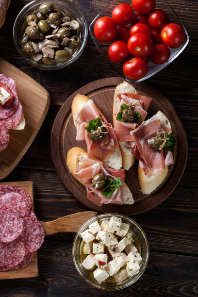 istock Spanish tapas with slices jamon serrano, salami, olives and chee 697536190