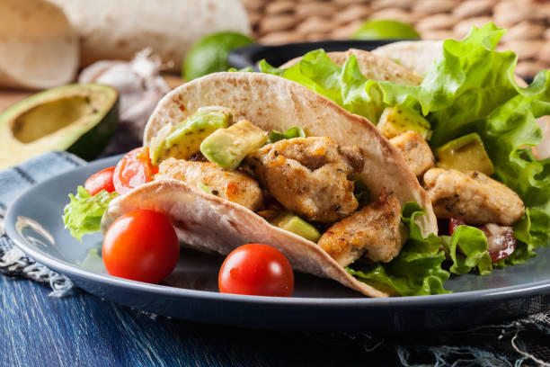istock Authentic mexican tacos with chicken and salsa with avocado, tomatoes and chillies 697538996