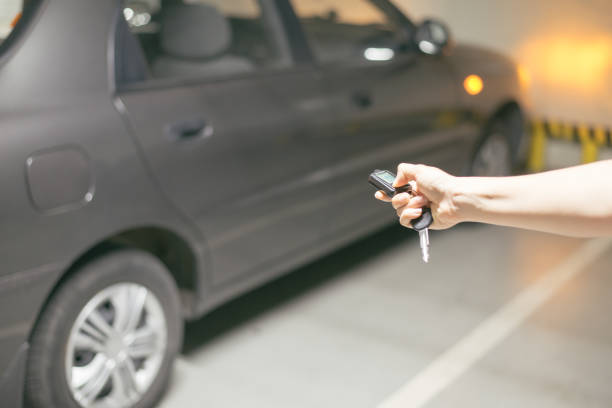 istock hand presses on the remote control car alarm systems 697539232