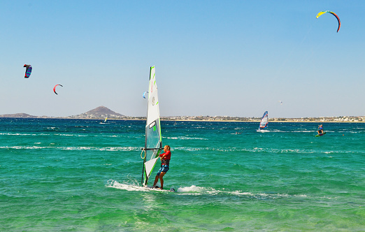 NAXOS GREECE, AUGUST 27 2014: people doing kitesurf and windsurf at Naxos island Cyclades Greece. Editorial use.