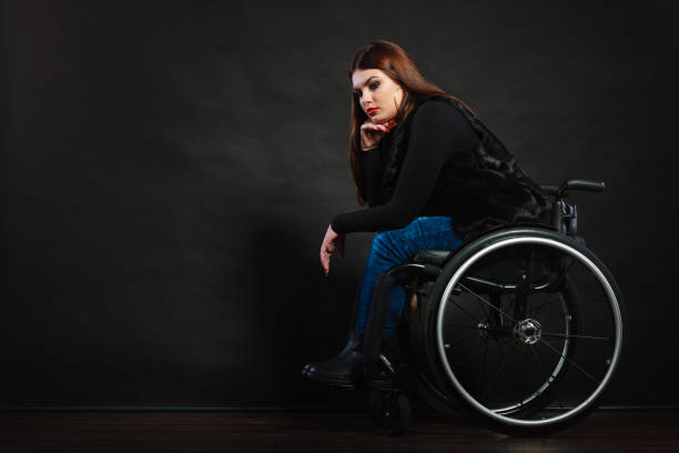 istock Sad girl in a wheelchair. 697541686