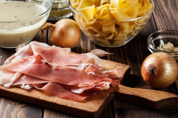 istock Ingredients ready for preparing pappardelle with prosciutto and cheese sauce 697541850