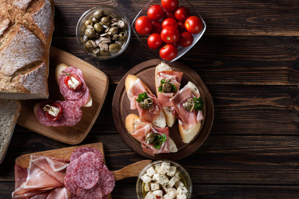 istock Spanish tapas with slices jamon serrano, salami, olives and chee 697542004