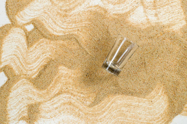 istock Glass on the sand.Show for material made glass. 697545492