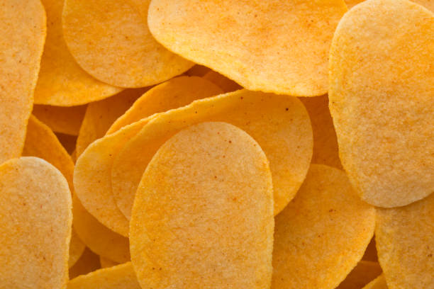 istock Close up potato chips on wood top view background. 697545558