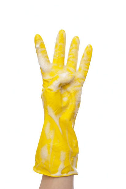 istock Hand in yellow glove four fingers 697548264