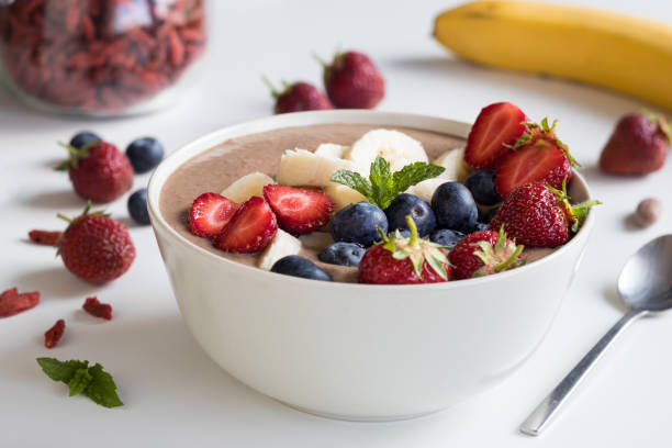 istock Summer breakfast - raw breakfast bowl with strawberries and blueberries 697548438
