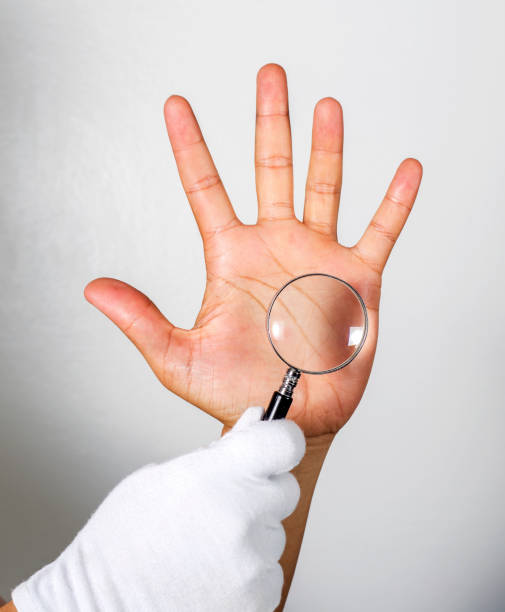 istock Looking at the lines on the hand through a magnifying glass.On t 697549042