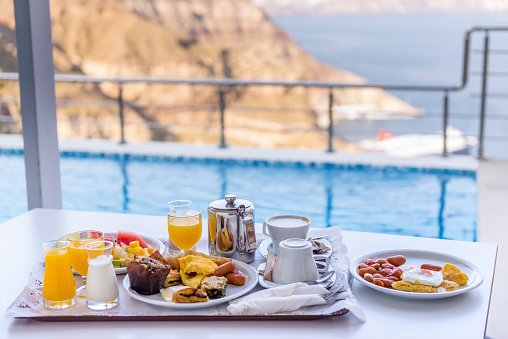 Relaxing outdoors with a delicious breakfast and beautiful view on mountains, travel and healthy lifestyle concept