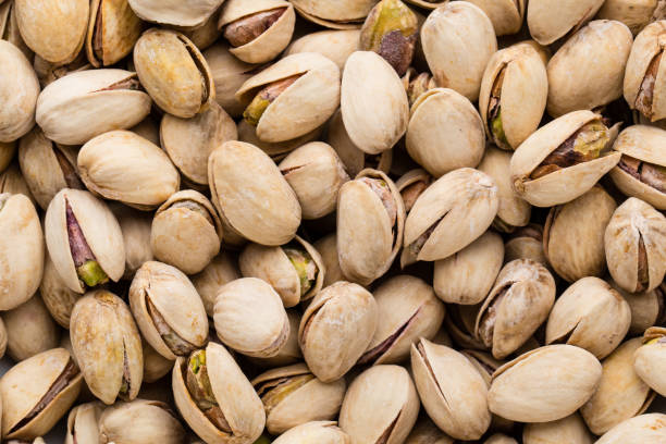 istock Roasted and salted pistachios in shell. 697549352