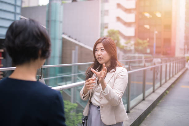 istock Business women discussing on street 697549626