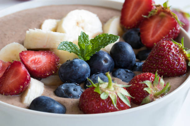 istock Summer breakfast - raw breakfast bowl with strawberries and blueberries 697552004