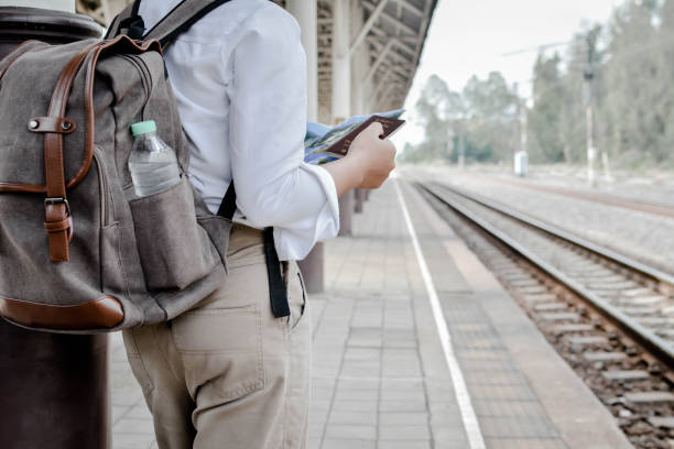 istock Rear View Of Man Standing On Railway Station Platform 697553189