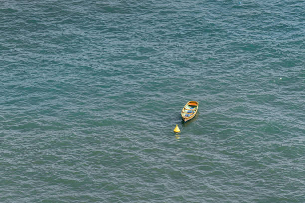Empty single boat near buoy in the sea