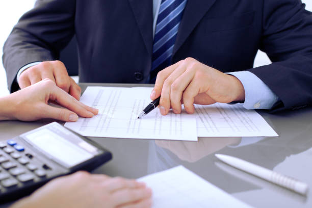 istock Bookkeepers or financial inspector making report, calculating or checking balance. Audit concept. 697555150
