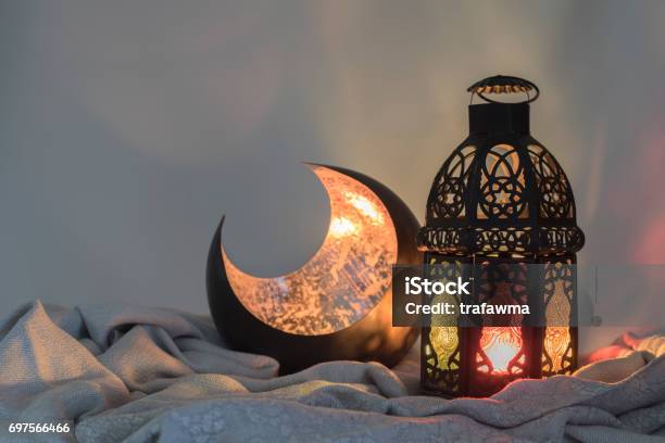 Lantern And A Copper Crescent Shape On A Satin Cloth Stock Photo - Download Image Now