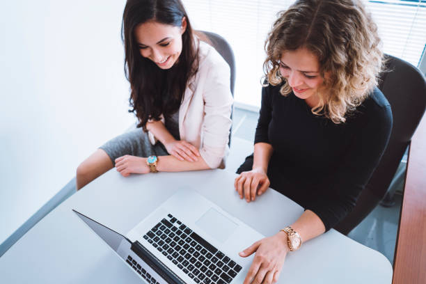 istock Two women working together in office 697566582