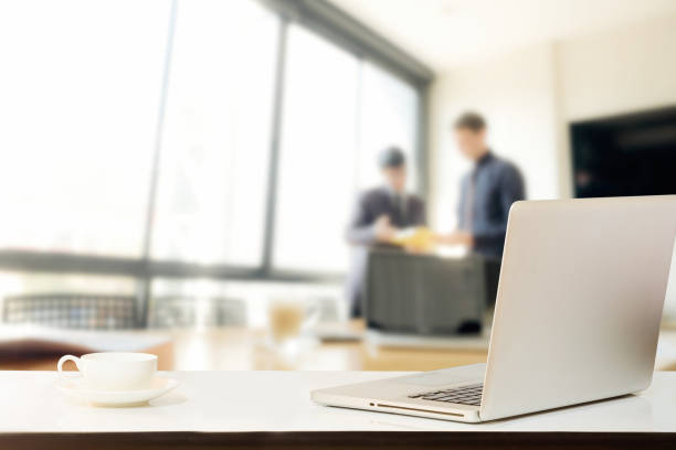 istock Laptop with coffee on table in meeting room. 697566674