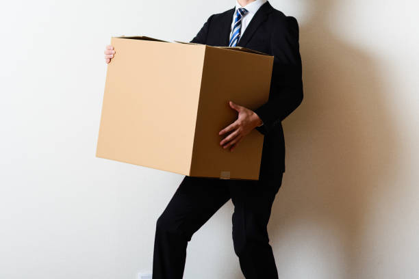 istock Businessman carrying a cardboard box 697569666