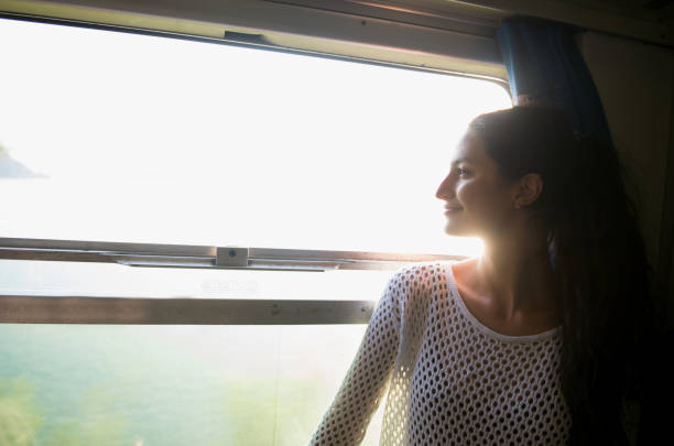 Smiling woman looking at the view from train