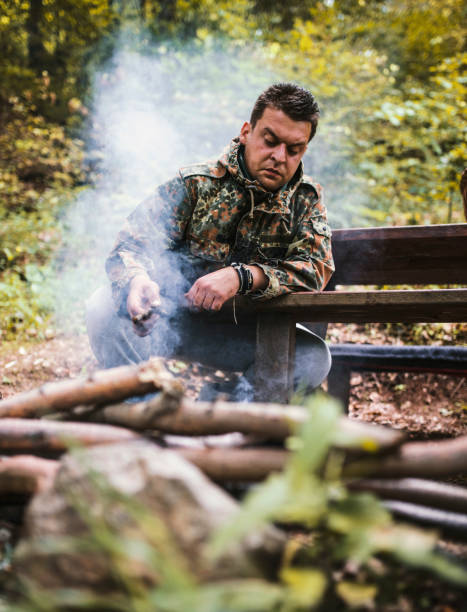 istock Preparing food on grill in forest 697572980