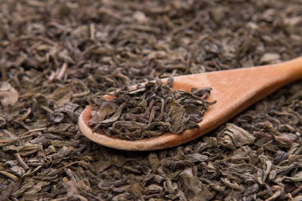 istock Dry green tea leaves background texture 697579992