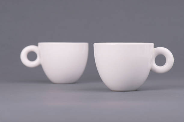 istock Two white coffee cup on grey background. Design template for Mock Up 697586418