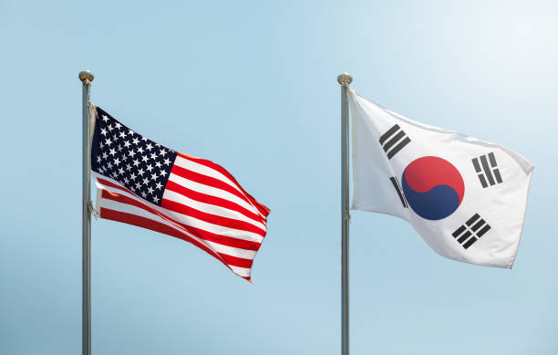 waving the american flag, the star-spangled banner, the stars and stripes and south korean flag on blue sky, korean and us alliance, us and korean alliance - star spangled banner imagens e fotografias de stock
