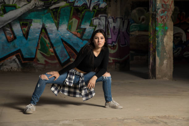 istock Hip hop dancer in front of graffiti wall 697587268