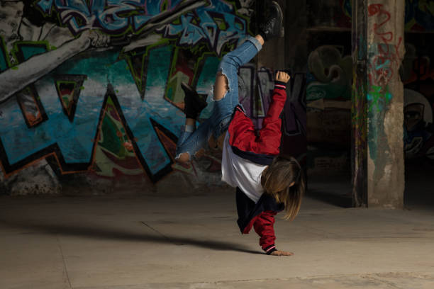istock Female urban dancer standing on one hand 697587402