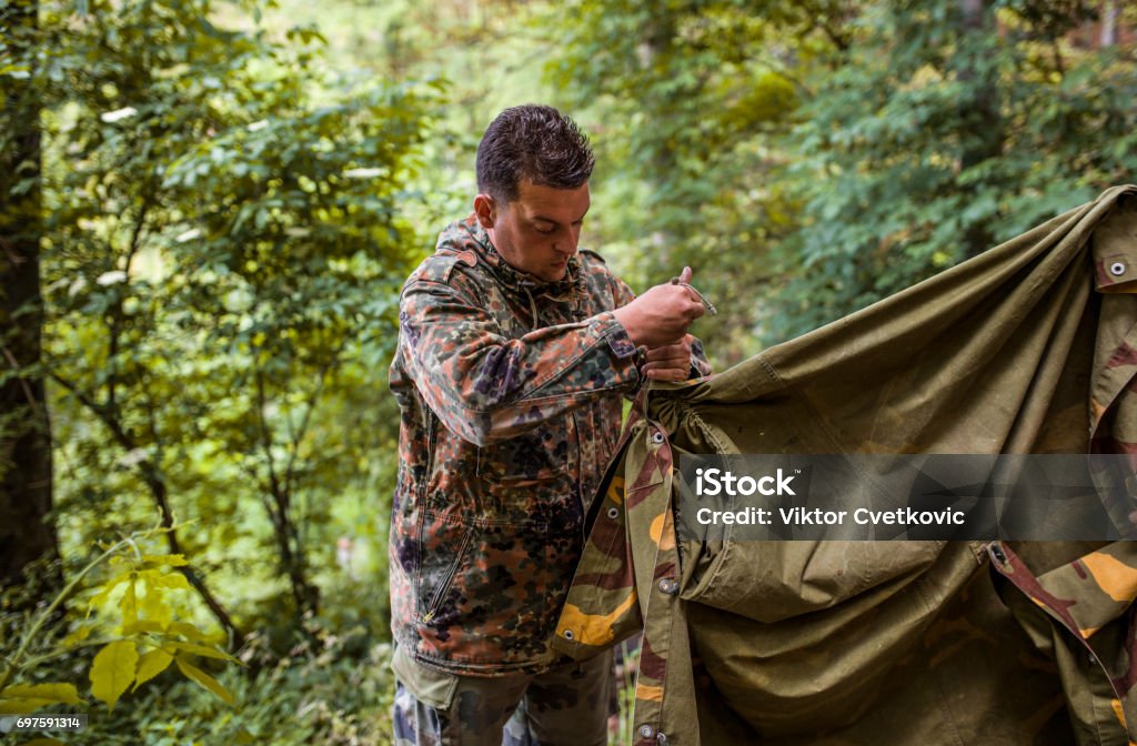 Soldier construct the tent Soldier construct the tent in forest Camping Stock Photo