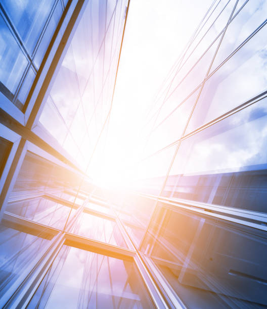 istock Bright future, finance buildings seen from below, sun 697594058
