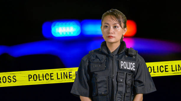 istock Asian American Policewoman using police radio 697601342