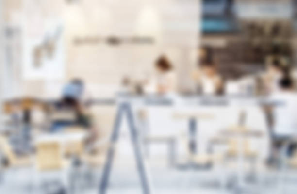 istock Blurred image of a chocolate shop with waitresses and customers. 697603700