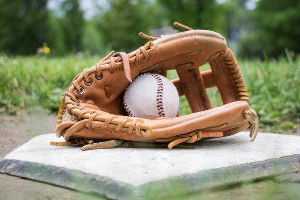 istock Glove and Baseball on Home Plate 697604348