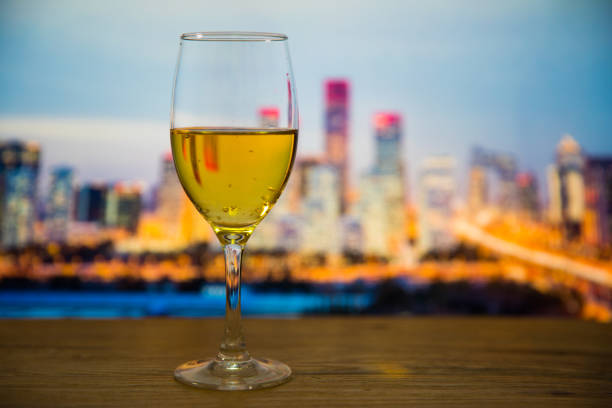 istock Champagne glasses with city background 697604544