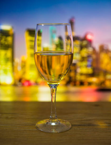 istock Champagne glasses with city background 697604768
