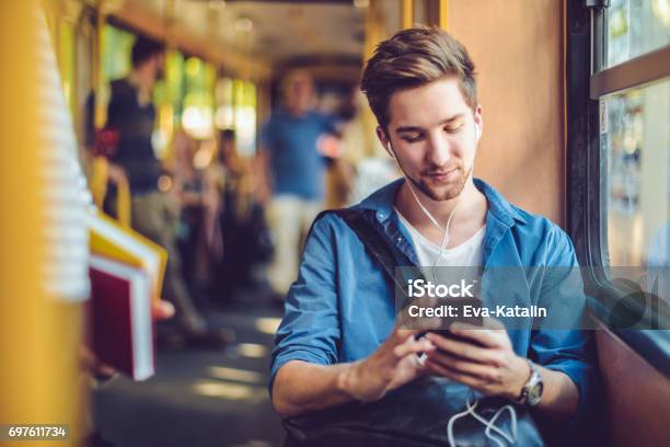 Checking Messages Stock Photo - Download Image Now - Bus, Men, Smart Phone