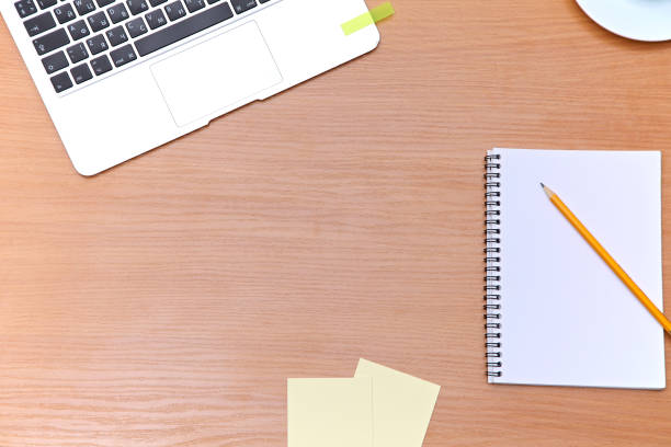 istock Office table with laptop, notepad and coffee cup. View from above with copy space 697611862
