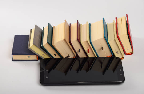 istock High Angle View Of Mobile Phone By Books On White Background 697614115