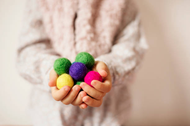 Close up of children hands holding colorful felt balls. Child, kid palms. A little girl keep in handfuls of colored wool balls. Lifestyle concept. Selective focus Close up of children hands holding colorful felt balls. Child, kid palms. A little girl keep in handfuls of colored wool balls. Lifestyle concept. Selective focus felt heart shape small red stock pictures, royalty-free photos & images