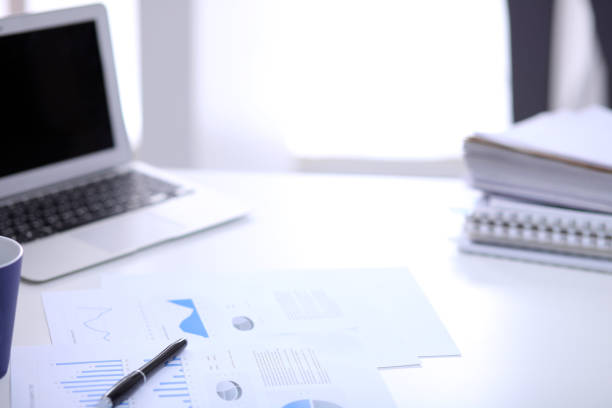 istock Office workplace with a laptop and financial documents 697637026