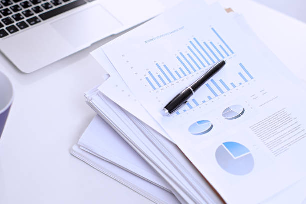 istock Office workplace with a laptop and financial documents 697637256