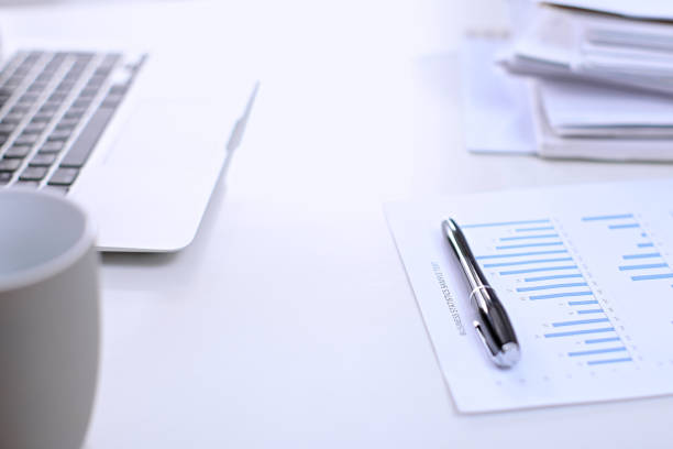 istock Office workplace with a laptop and financial documents 697637320