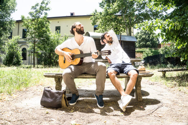 istock Couple of men playing guitar and having fun 697637700
