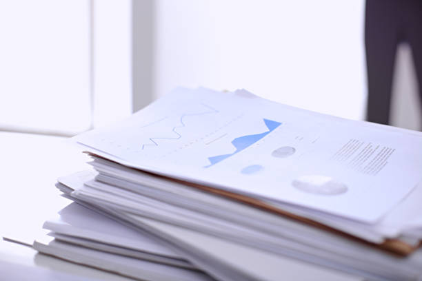 istock Office workplace with a laptop and financial documents 697639368