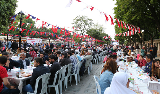 ISTANBUL, TURKEY - MAY 27, 2017: People waiting for the evening meal during Ramadan in Sultanahmet square. Sultanahmet district is the most populer place for Ramadan activities in Istanbul.